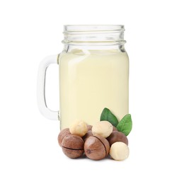Image of Nut milk in glass jar and macadamias isolated on white