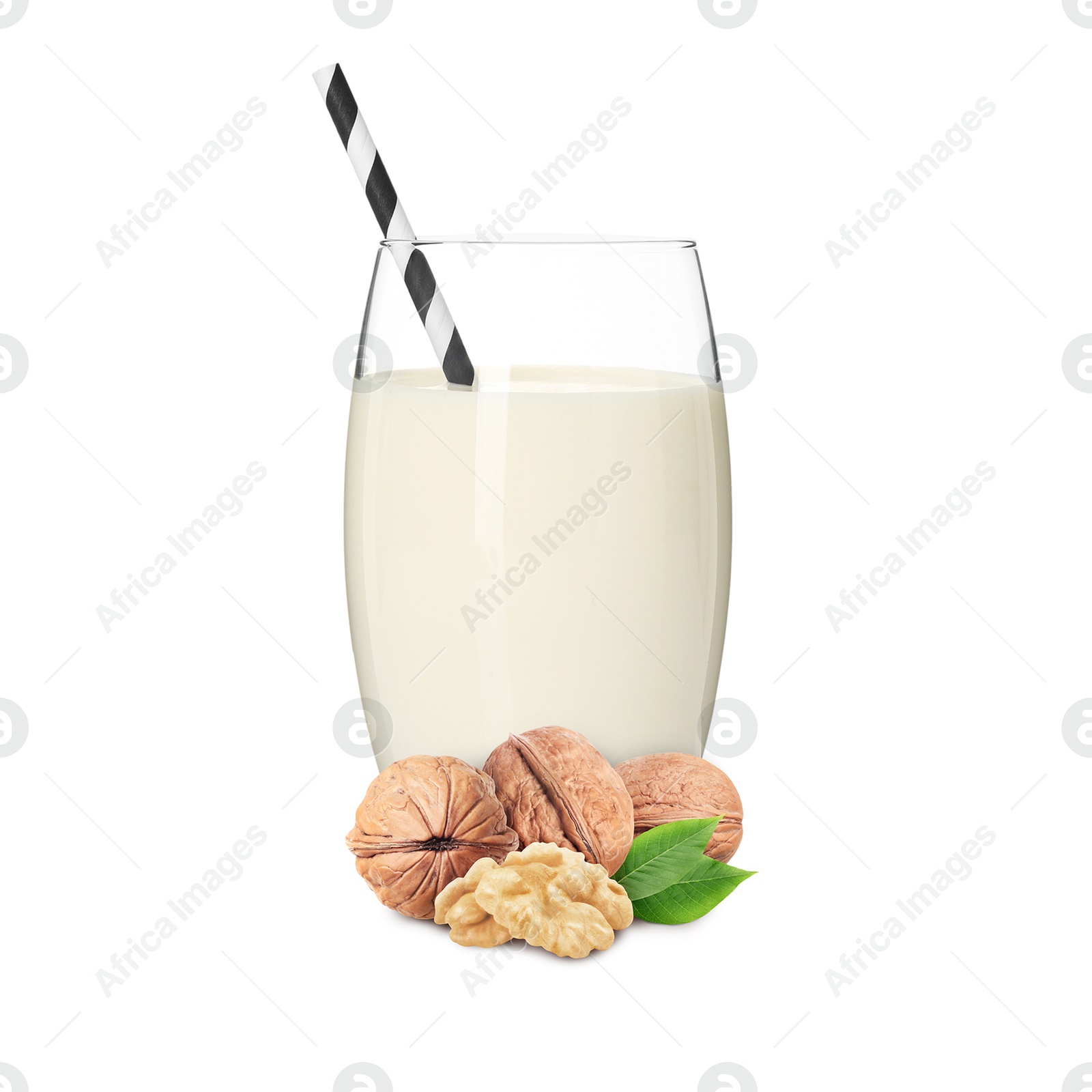 Nut milk in glass and walnuts isolated on white Image of Nut milk in glass and walnuts isolated on white