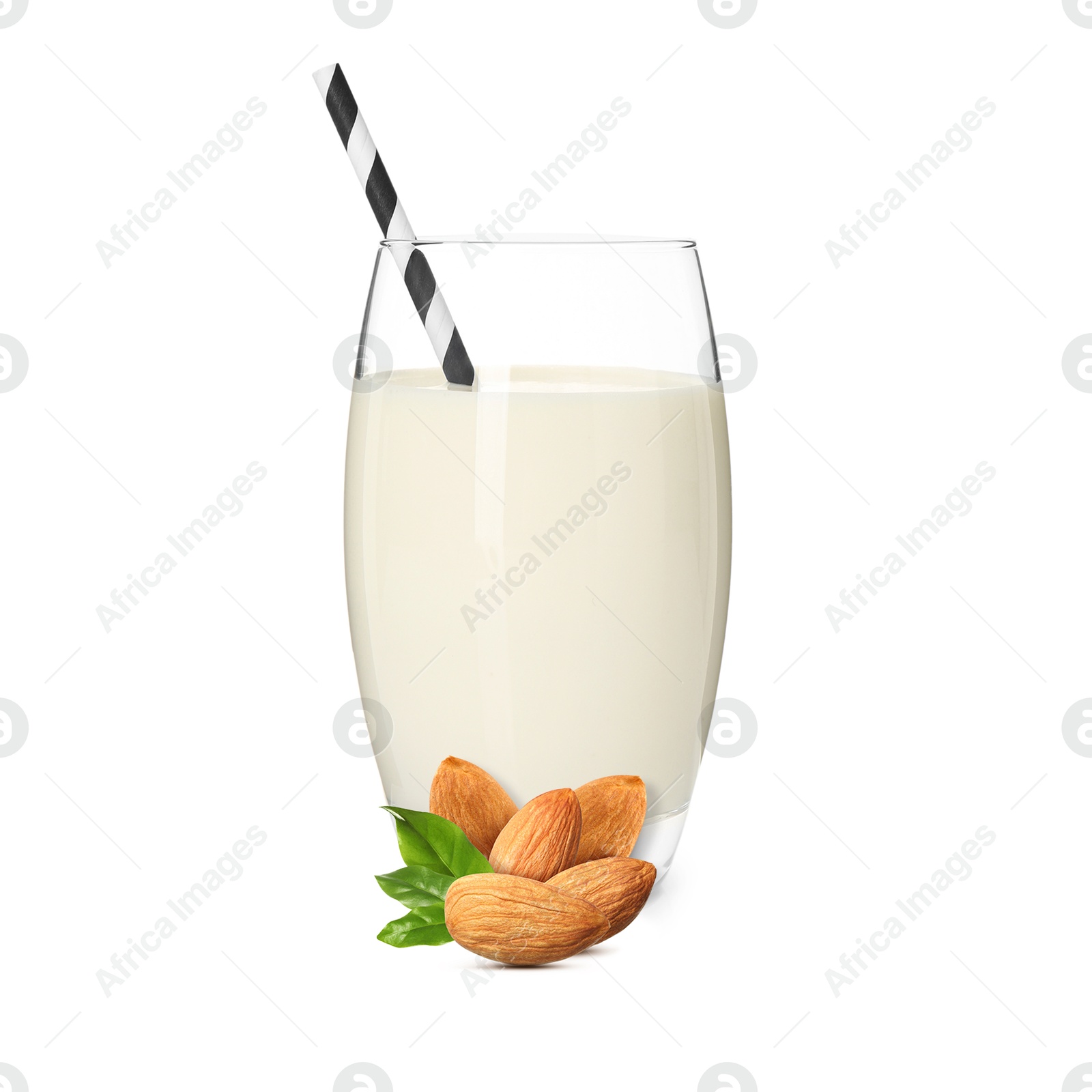 Nut milk in glass and almonds isolated on white Image of Nut milk in glass and almonds isolated on white