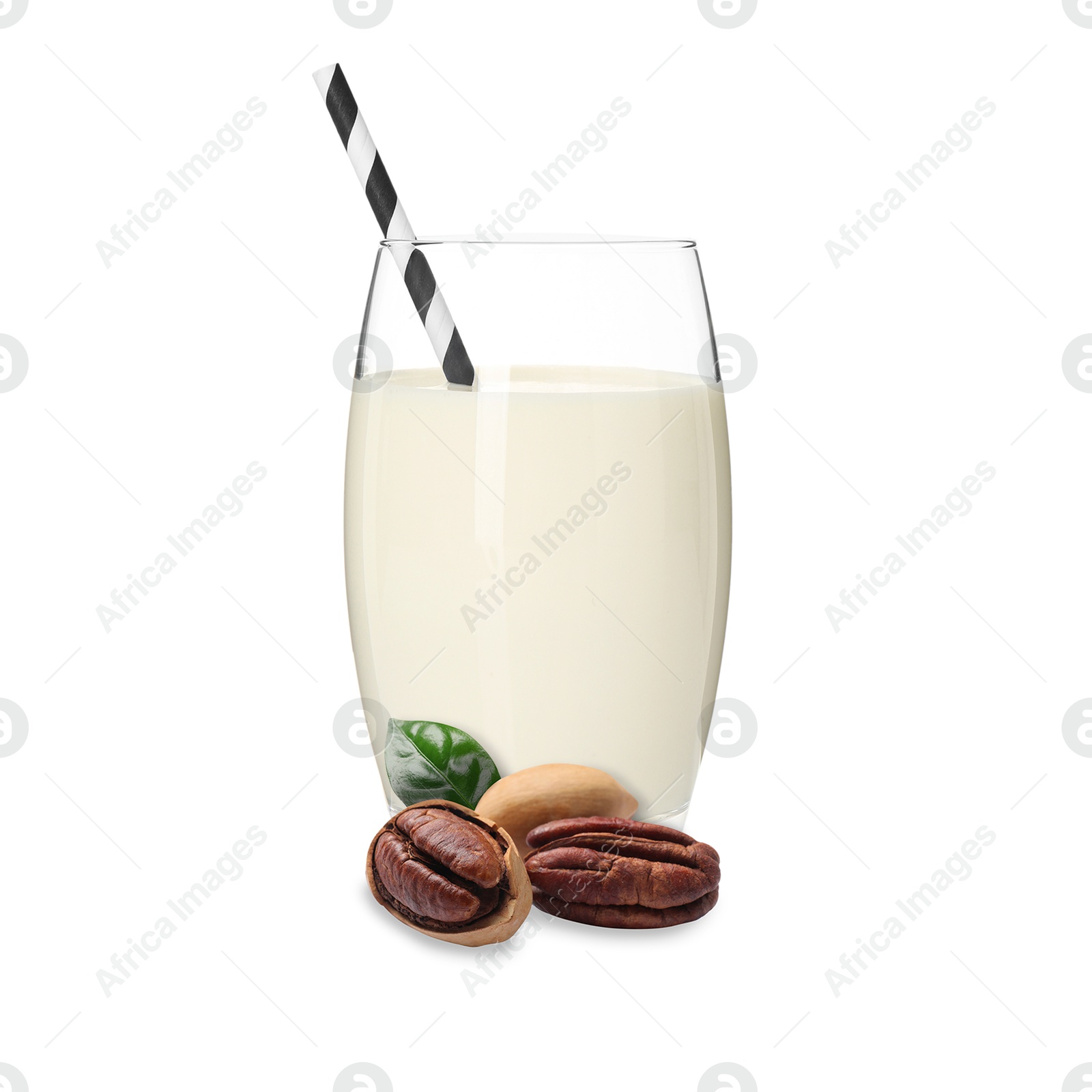Nut milk in glass and pecans isolated on white Image of Nut milk in glass and pecans isolated on white
