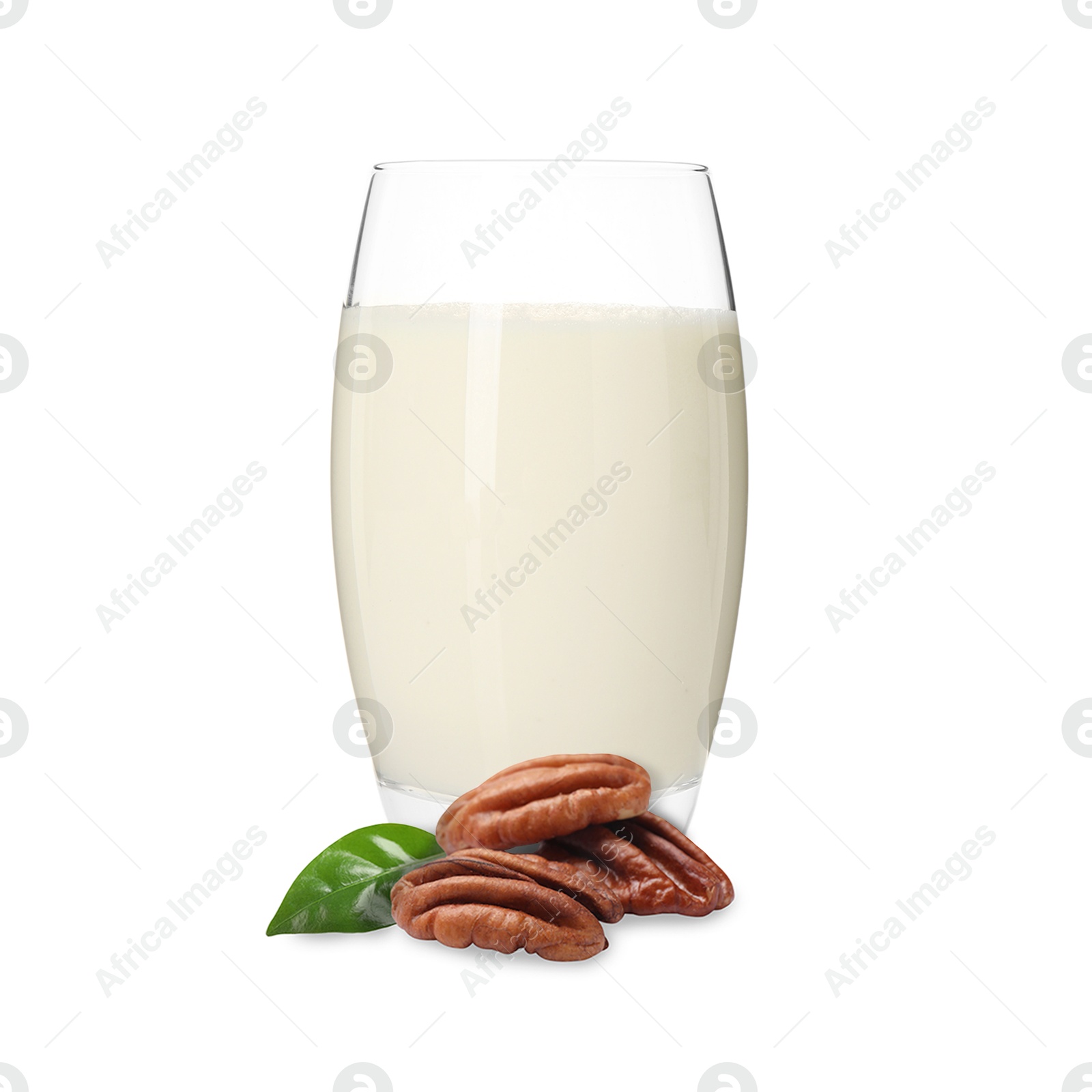 Nut milk in glass and pecans isolated on white Image of Nut milk in glass and pecans isolated on white
