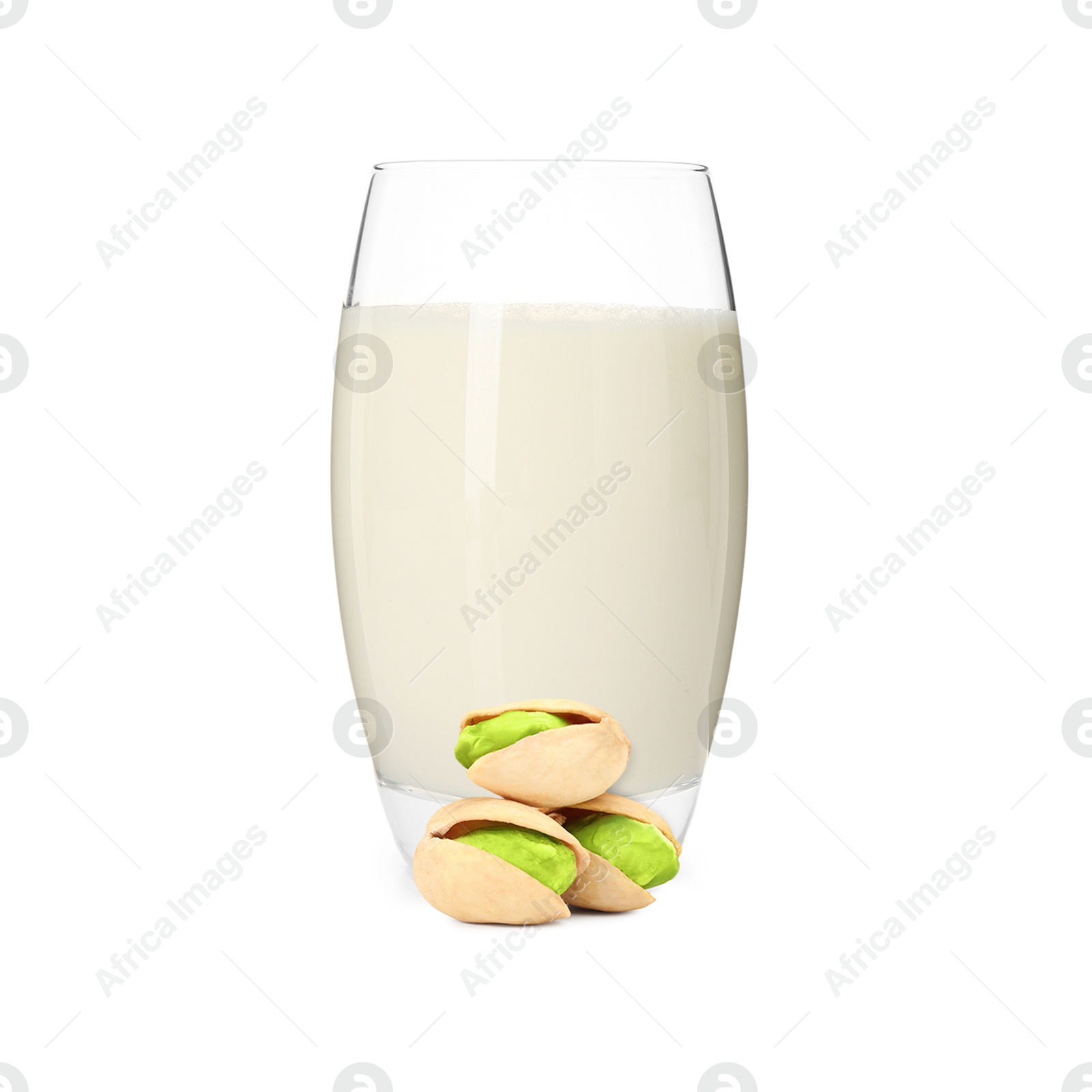 Nut milk in glass and pistachios isolated on white Image of Nut milk in glass and pistachios isolated on white