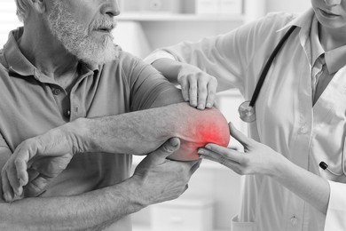 Image of Arthritis. Doctor examining patient's elbow in hospital, closeup. Black and white toning with red color accent