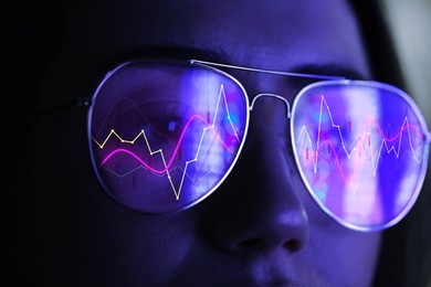 Image of Stock exchange. Trader analyzing data, closeup. Graphs reflecting in her eyeglasses