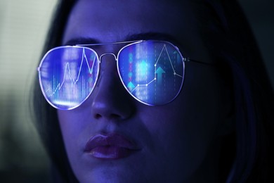 Image of Stock exchange. Trader analyzing data, closeup. Graphs reflecting in her eyeglasses