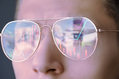 Image of Stock exchange. Trader analyzing data, closeup. Graphs reflecting in his eyeglasses