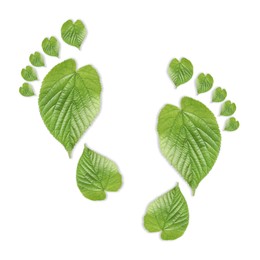 Image of Human footprints made of green leaves on white background, top view. Environmental care, ecology protection, reducing CO2 emission
