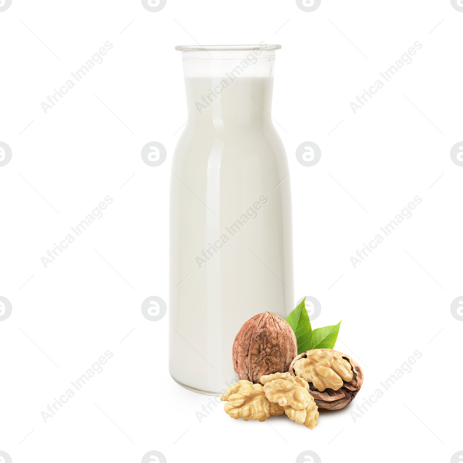 Nut milk in glass bottle and walnuts isolated on white Image of Nut milk in glass bottle and walnuts isolated on white