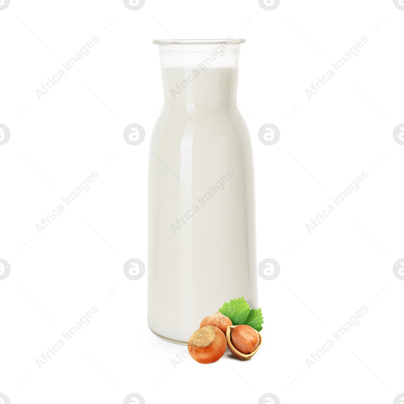Nut milk in glass bottle and hazelnuts isolated on white Image of Nut milk in glass bottle and hazelnuts isolated on white