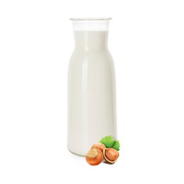Image of Nut milk in glass bottle and hazelnuts isolated on white