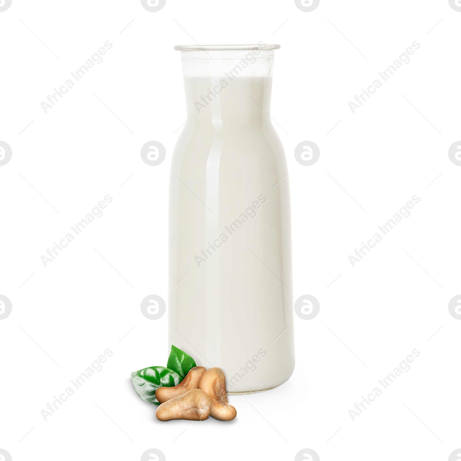Nut milk in glass bottle and cashews isolated on white Image of Nut milk in glass bottle and cashews isolated on white