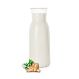 Image of Nut milk in glass bottle and cashews isolated on white