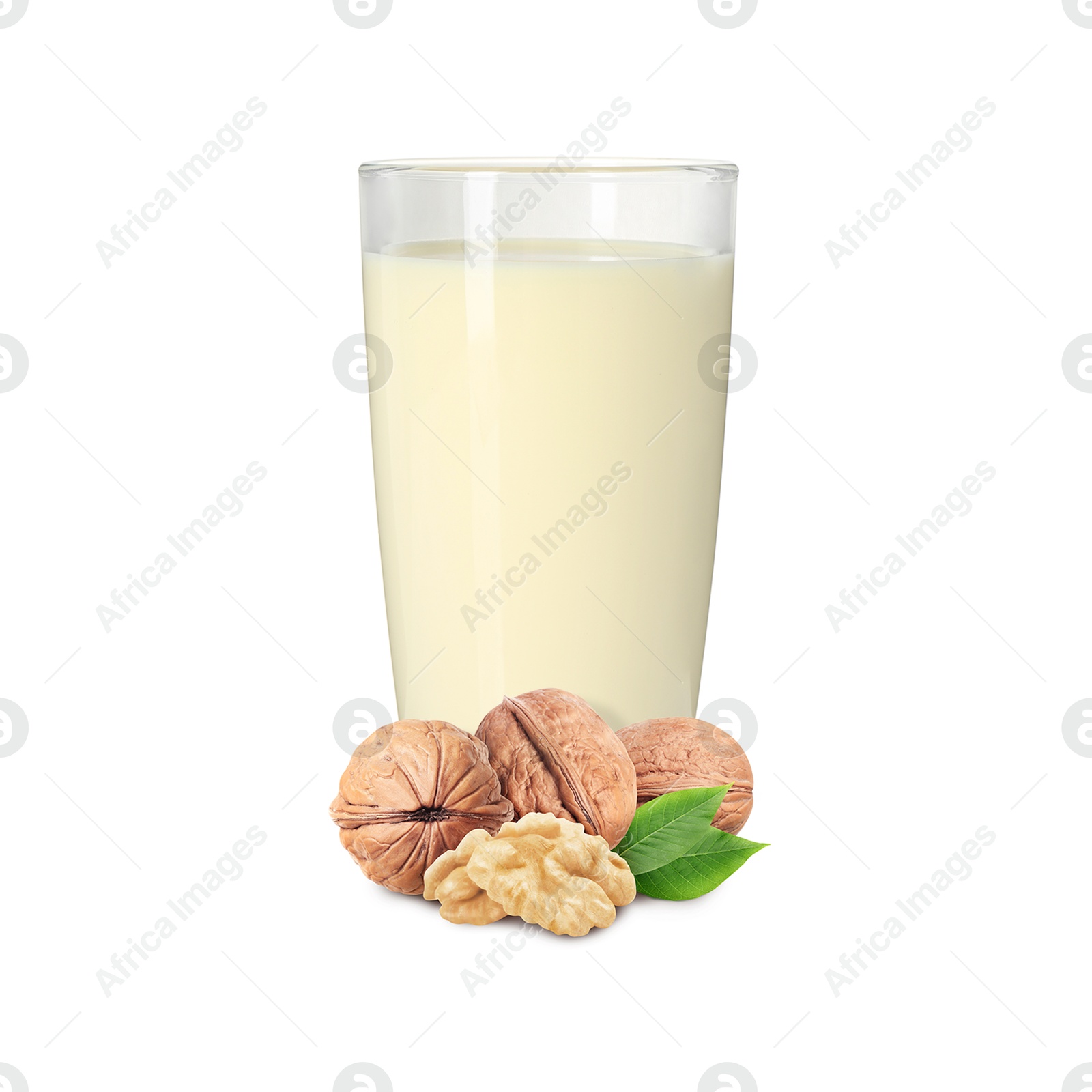 Nut milk in glass and walnuts isolated on white Image of Nut milk in glass and walnuts isolated on white