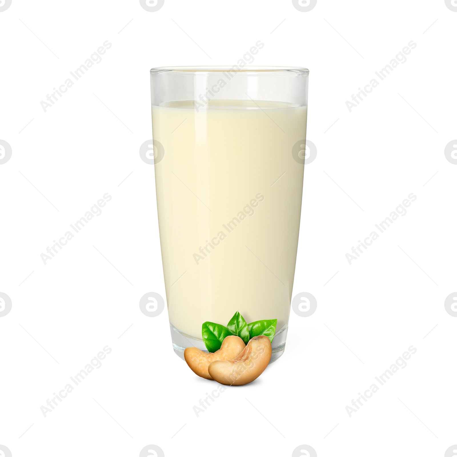 Nut milk in glass and cashews isolated on white Image of Nut milk in glass and cashews isolated on white