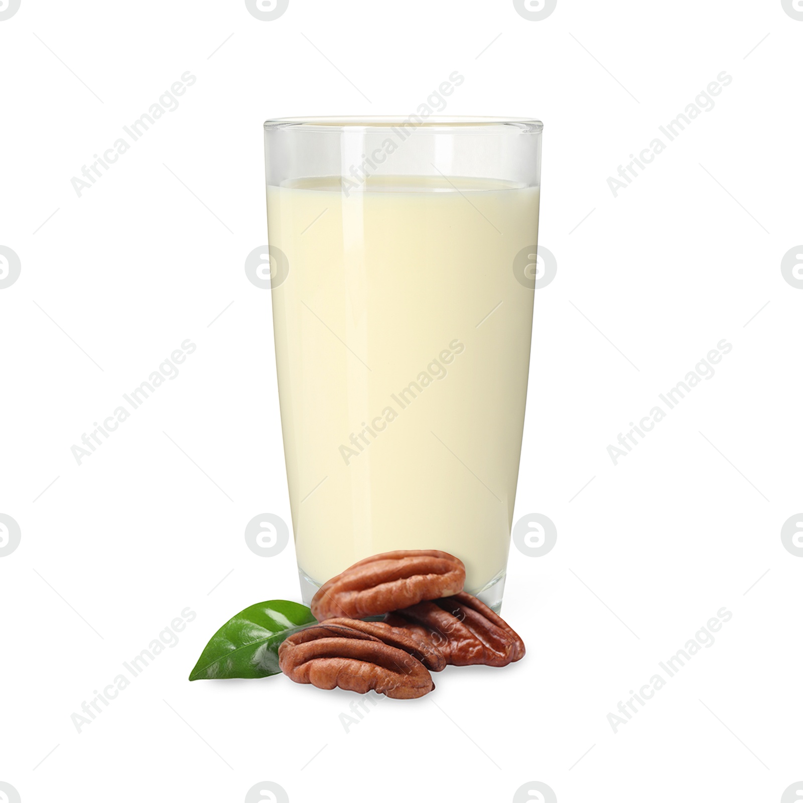 Nut milk in glass and pecans isolated on white Image of Nut milk in glass and pecans isolated on white
