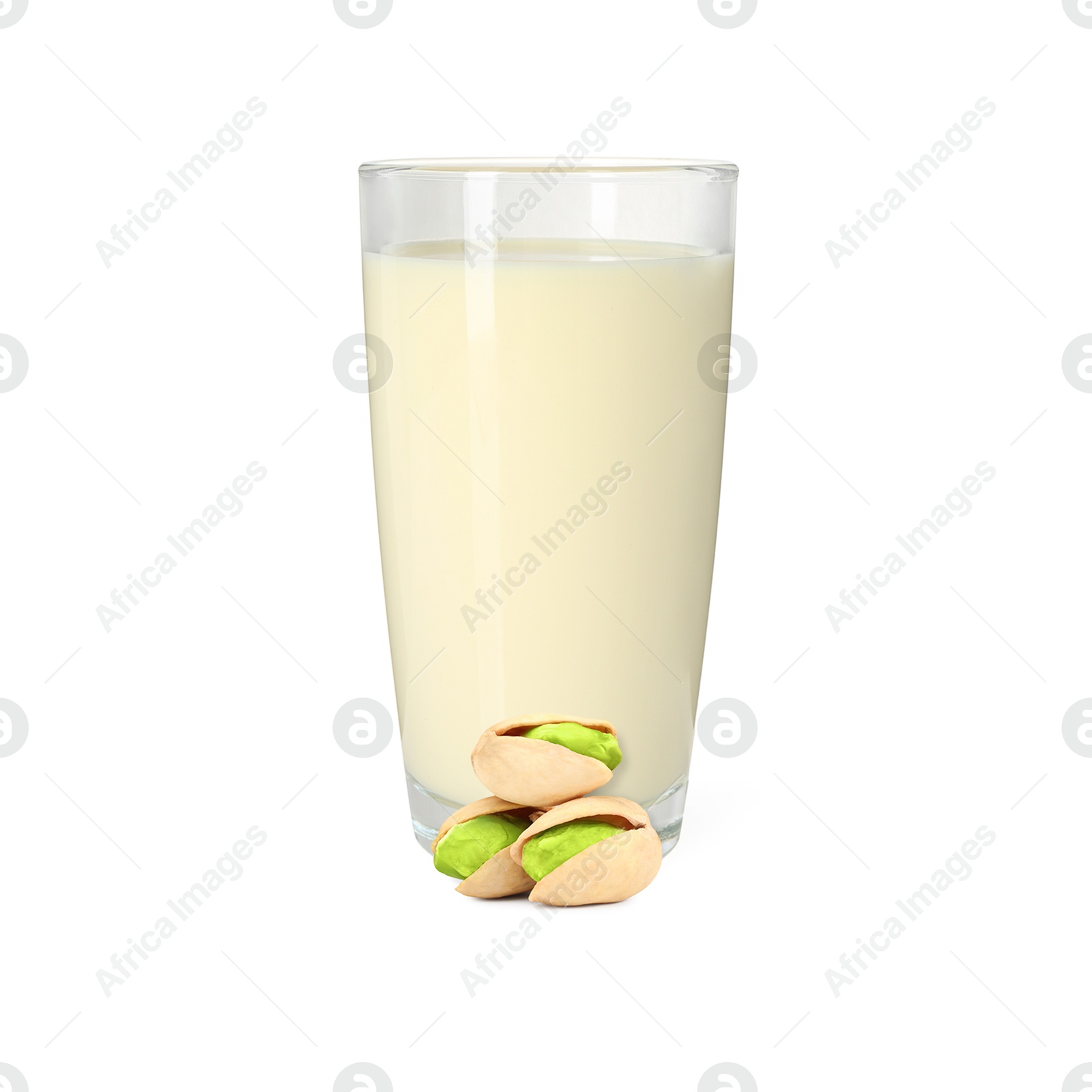 Nut milk in glass and pistachios isolated on white Image of Nut milk in glass and pistachios isolated on white