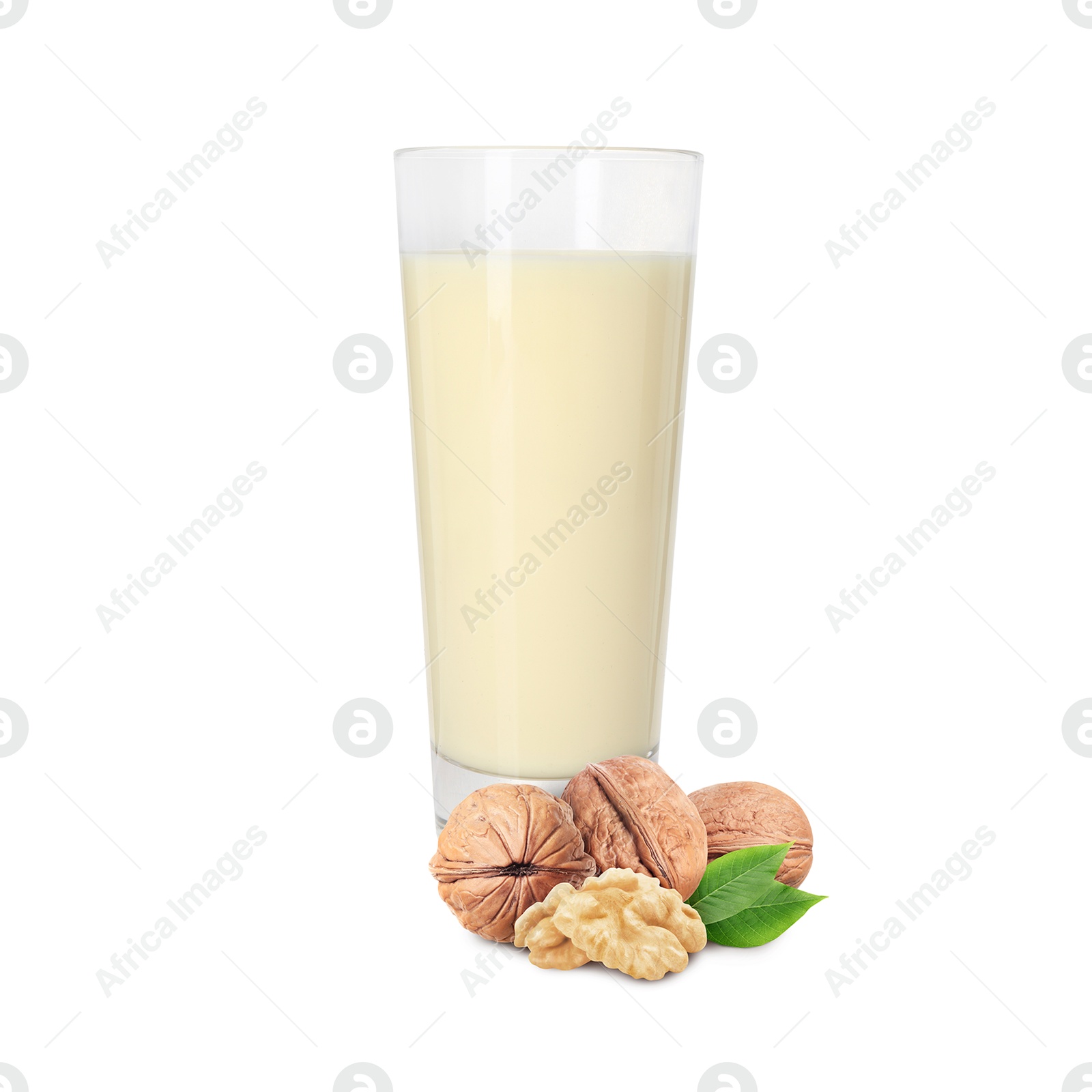 Nut milk in glass and walnuts isolated on white Image of Nut milk in glass and walnuts isolated on white