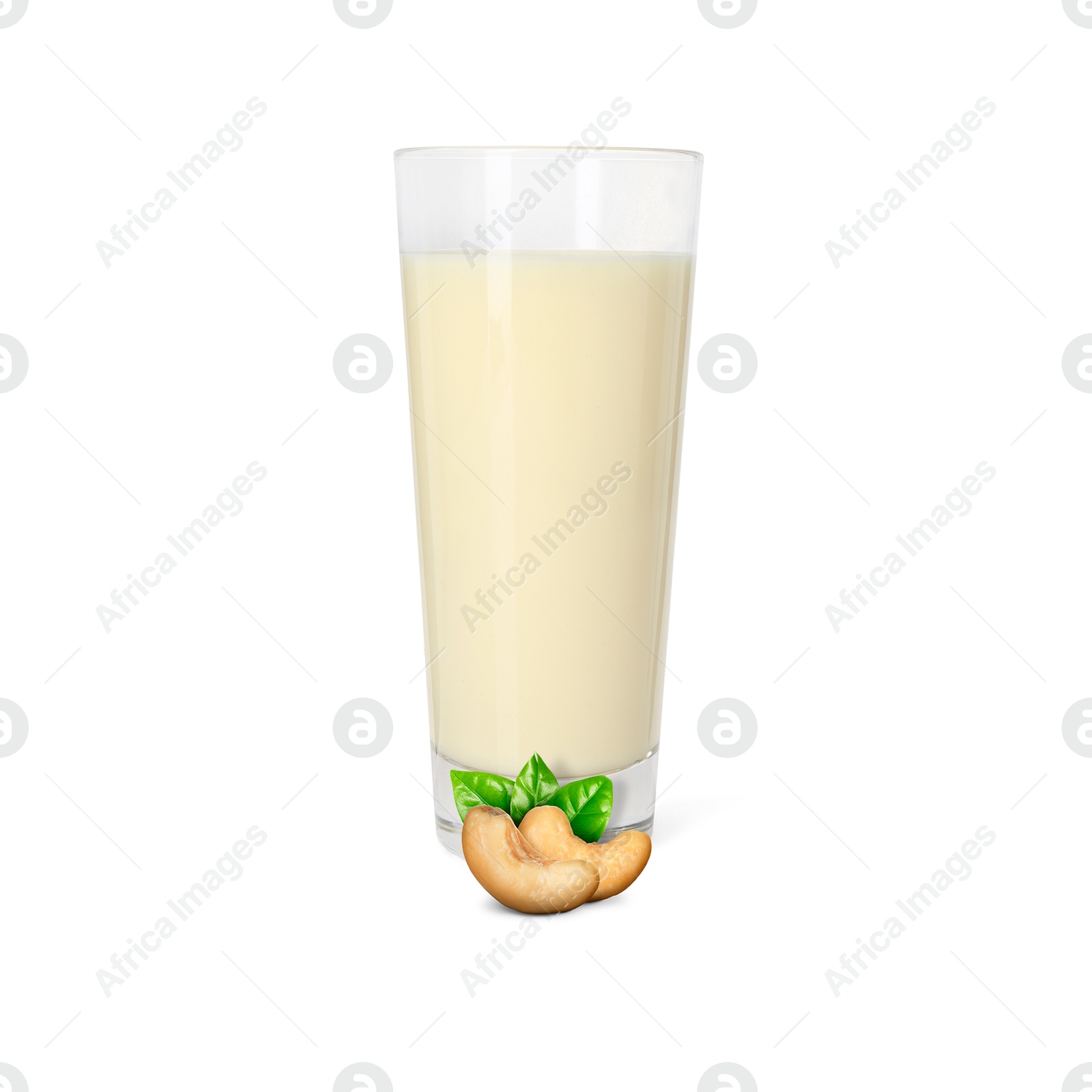 Nut milk in glass and cashews isolated on white Image of Nut milk in glass and cashews isolated on white
