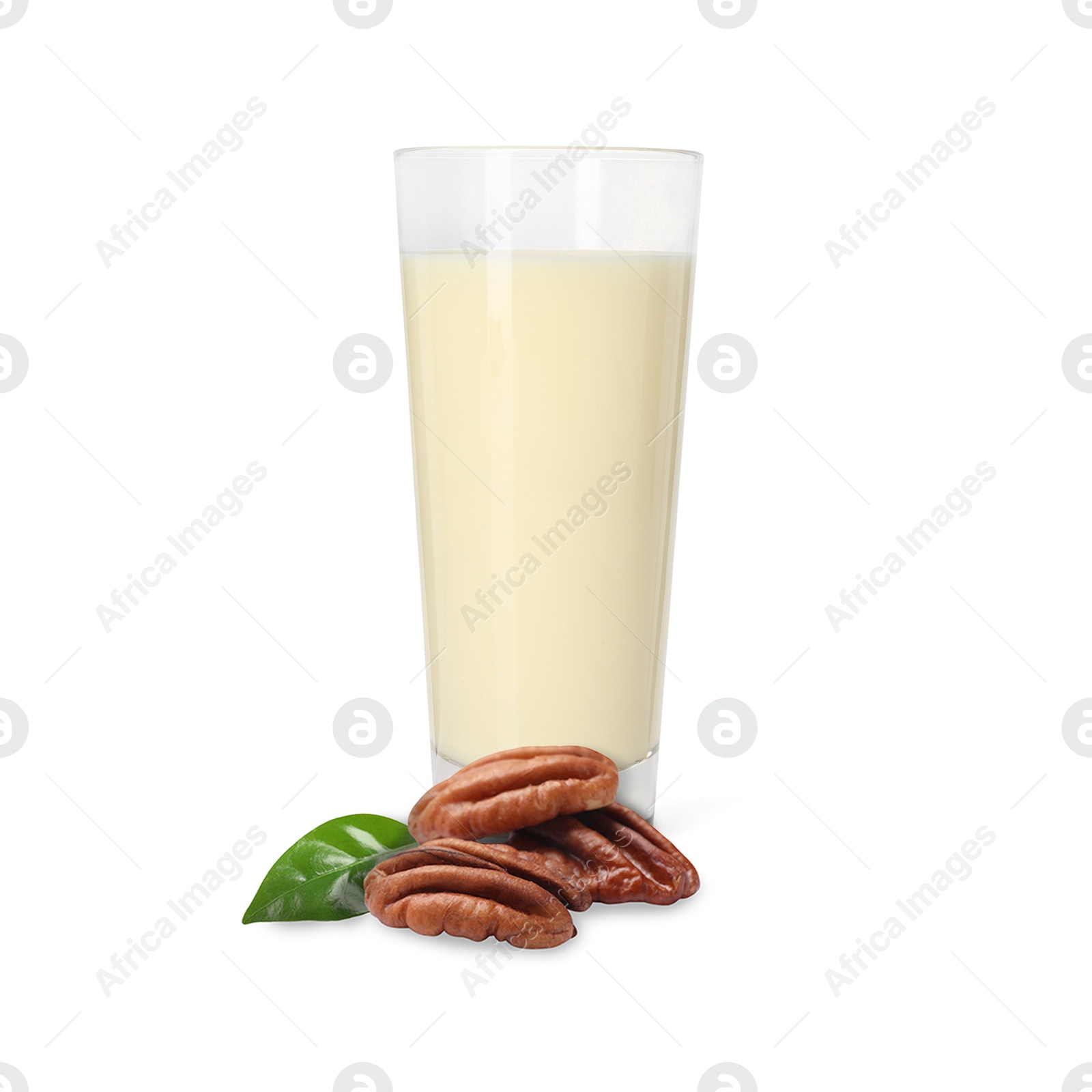 Nut milk in glass and pecans isolated on white Image of Nut milk in glass and pecans isolated on white