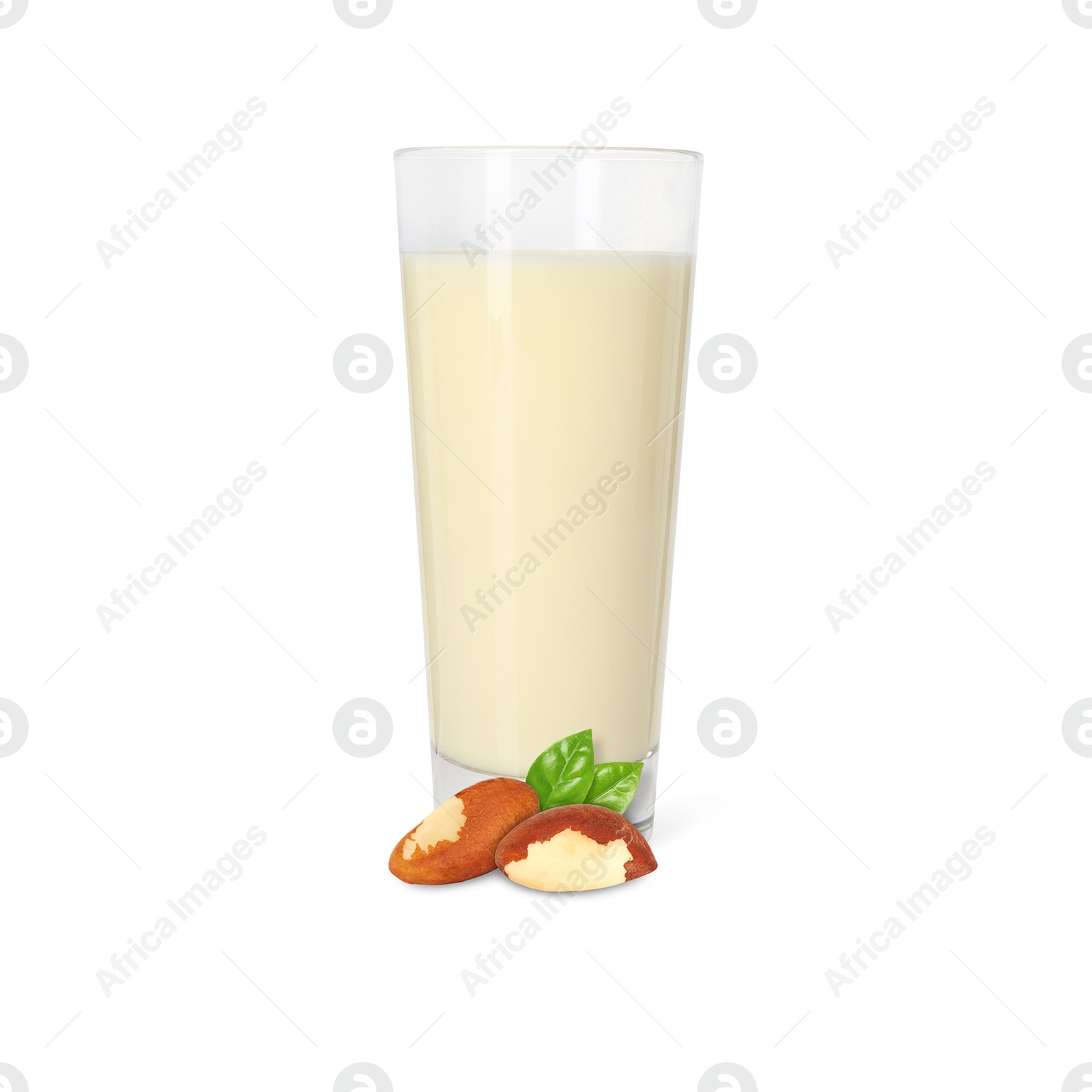 Nut milk in glass and Brazil nuts isolated on white Image of Nut milk in glass and Brazil nuts isolated on white