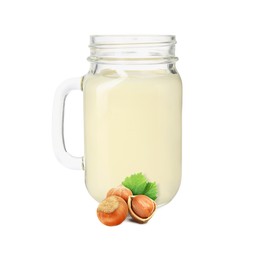 Image of Nut milk in glass jar and hazelnuts isolated on white