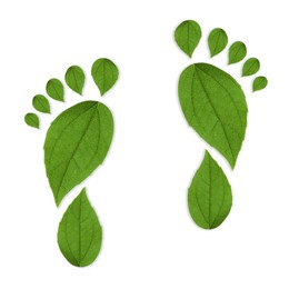 Image of Human footprints made of green leaves on white background, top view. Environmental care, ecology protection, reducing CO2 emission