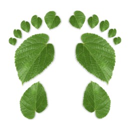 Image of Human footprints made of green leaves on white background, top view. Environmental care, ecology protection, reducing CO2 emission