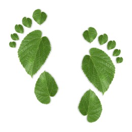 Image of Human footprints made of green leaves on white background, top view. Environmental care, ecology protection, reducing CO2 emission