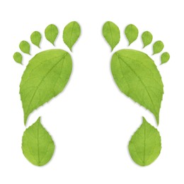 Image of Human footprints made of green leaves on white background, top view. Environmental care, ecology protection, reducing CO2 emission