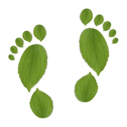 Image of Human footprints made of green leaves on white background, top view. Environmental care, ecology protection, reducing CO2 emission