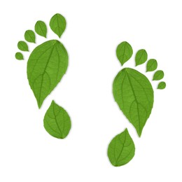 Image of Human footprints made of green leaves on white background, top view. Environmental care, ecology protection, reducing CO2 emission