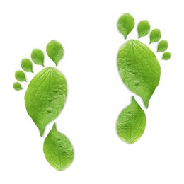 Image of Human footprints made of green leaves on white background, top view. Environmental care, ecology protection, reducing CO2 emission