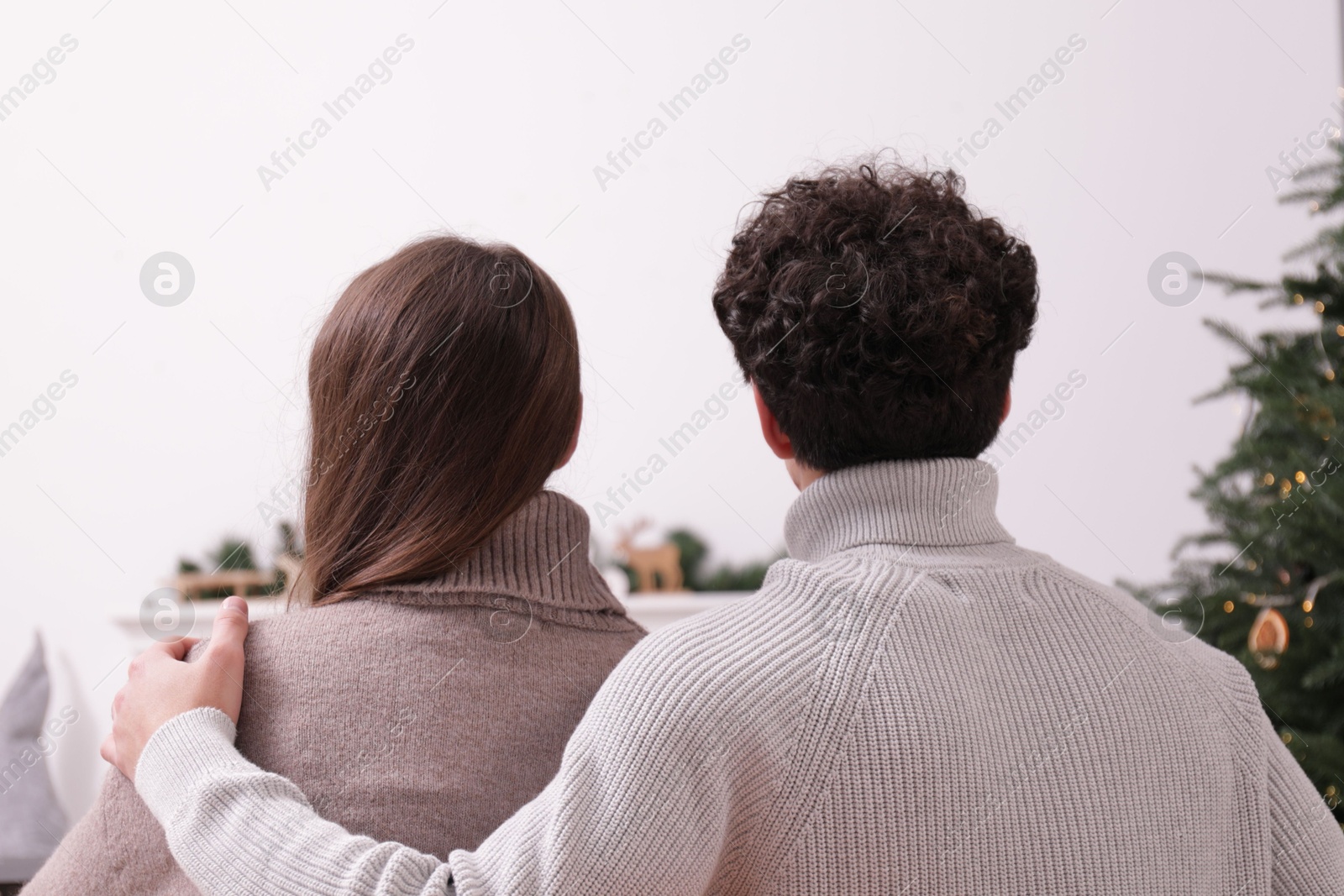 Couple watching movie via video projector at home, back view Photo of Couple watching movie via video projector at home, back view