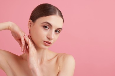 Photo of Portrait of beautiful young woman on pink background. Space for text