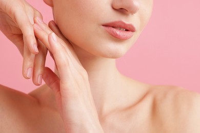 Photo of Beautiful woman posing on pink background, closeup