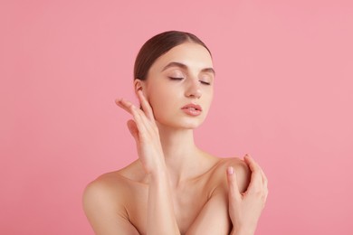 Photo of Portrait of beautiful young woman on pink background