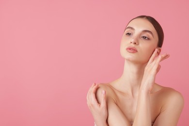 Photo of Portrait of beautiful young woman on pink background. Space for text