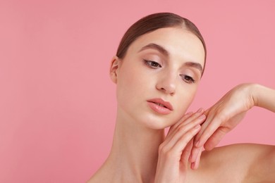 Photo of Portrait of beautiful young woman on pink background. Space for text