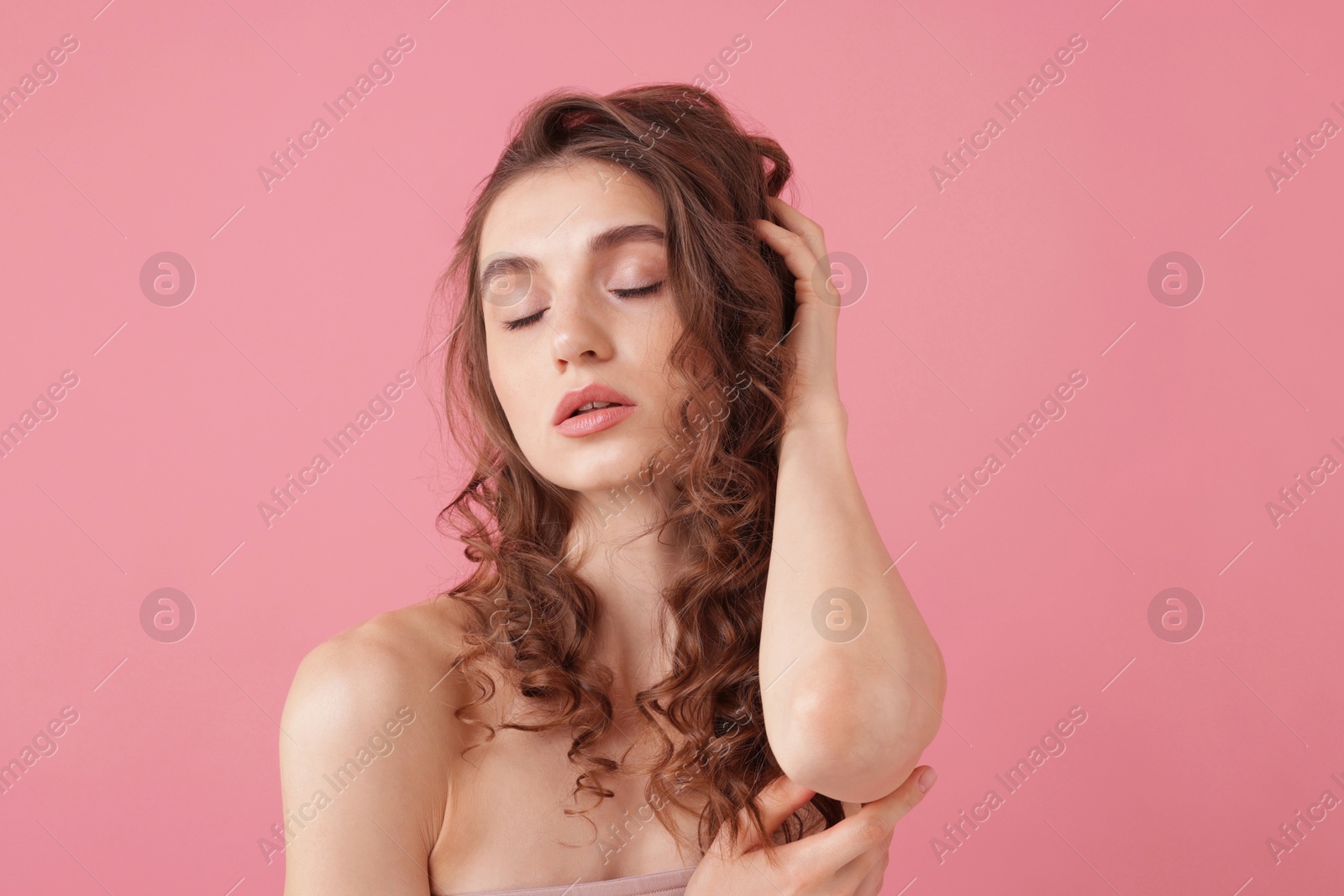 Portrait of beautiful young woman on pink background Photo of Portrait of beautiful young woman on pink background