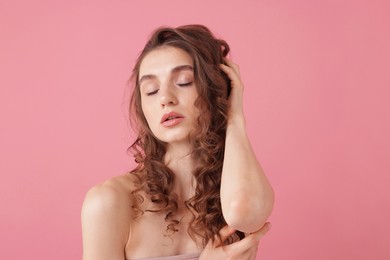 Photo of Portrait of beautiful young woman on pink background