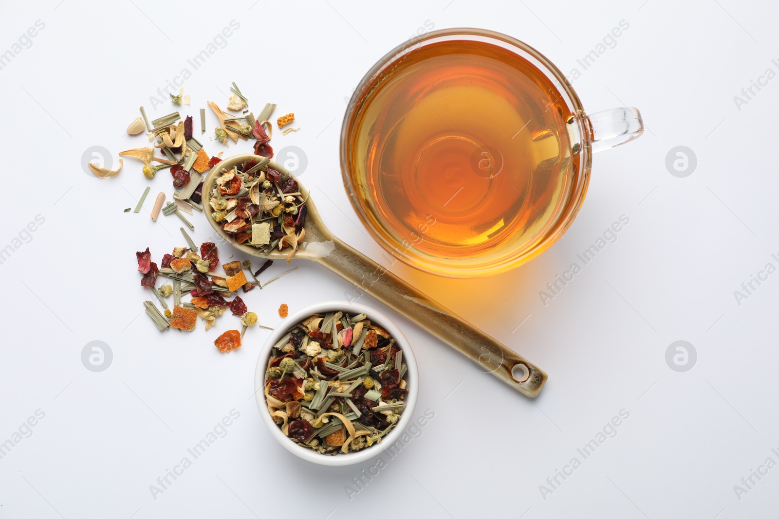 Delicious herbal tea and dry leaves on white background, top view Photo of Delicious herbal tea and dry leaves on white background, top view