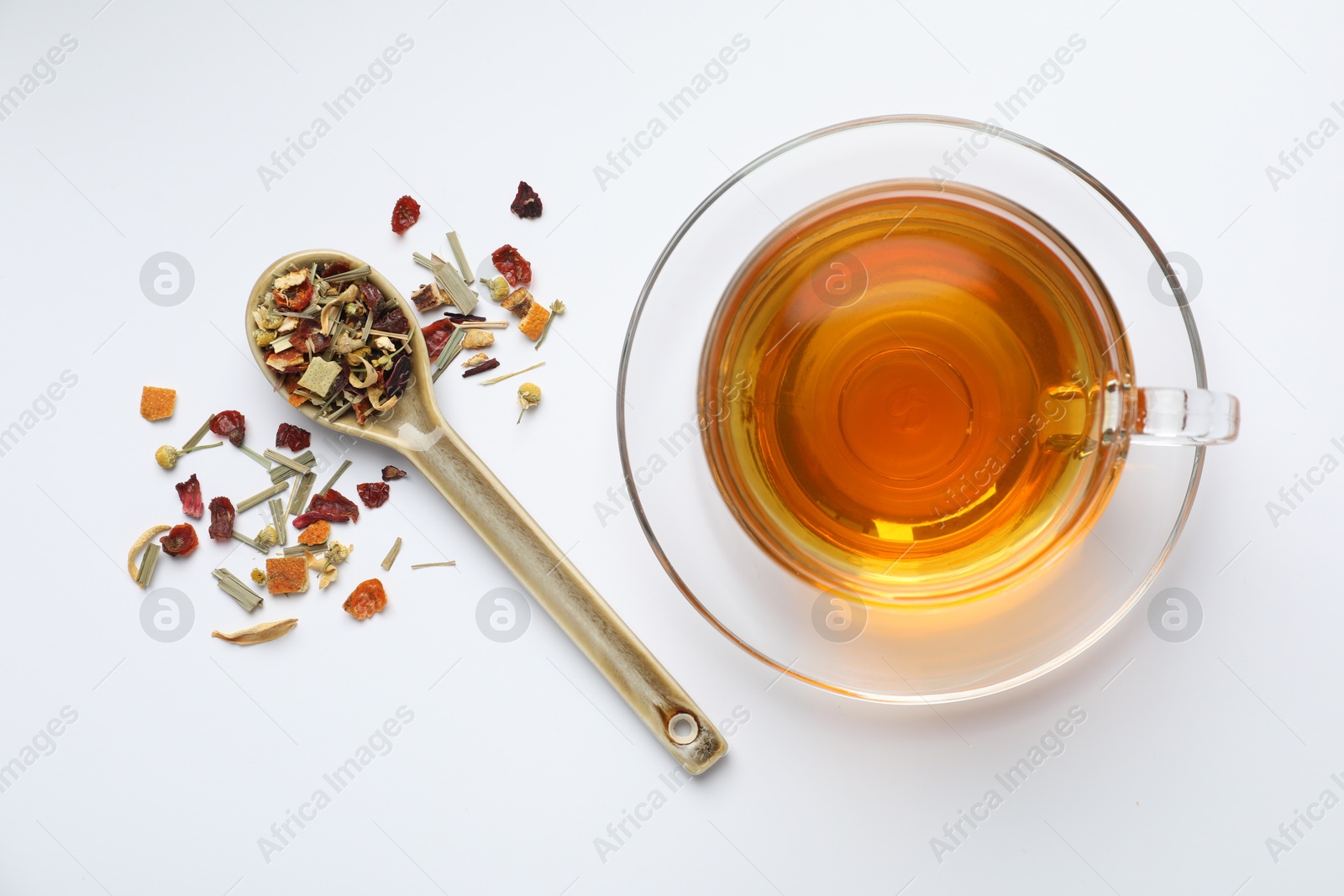 Delicious herbal tea and dry leaves on white background, top view Photo of Delicious herbal tea and dry leaves on white background, top view