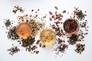 Photo of Different herbal teas and dry leaves on white background, flat lay