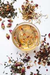 Photo of Delicious herbal tea and different brews on white background, flat lay