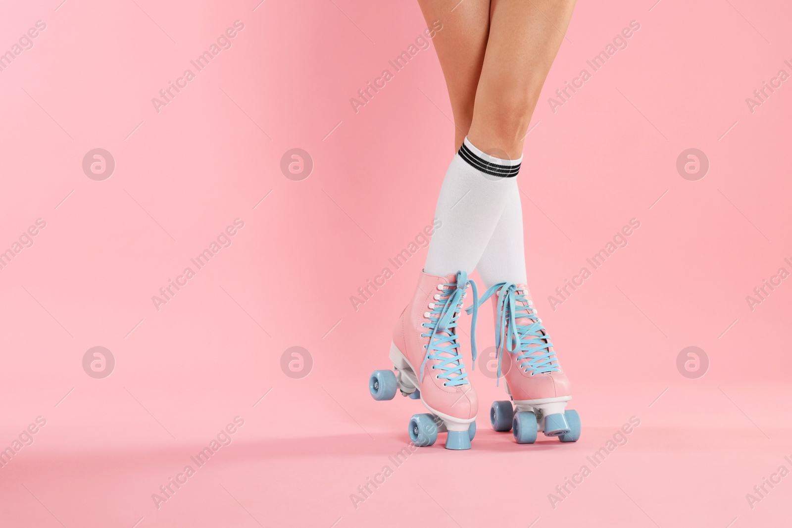 Woman in roller skates on pink background, closeup. Space for text Photo of Woman in roller skates on pink background, closeup. Space for text