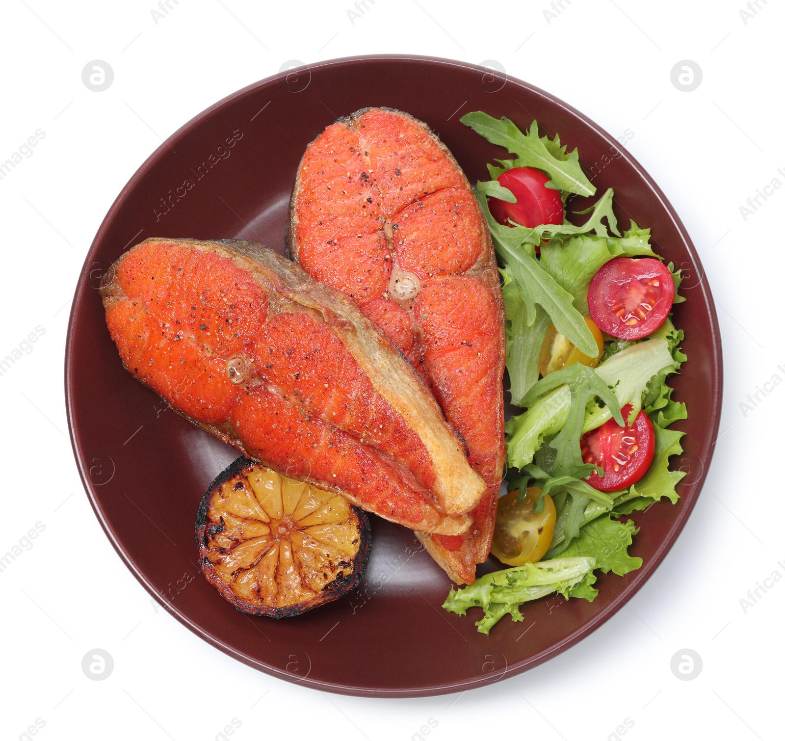 Seafood. Tasty salmon steaks, salad and lemon isolated on white, top view Photo of Seafood. Tasty salmon steaks, salad and lemon isolated on white, top view