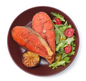 Photo of Seafood. Tasty salmon steaks, salad and lemon isolated on white, top view