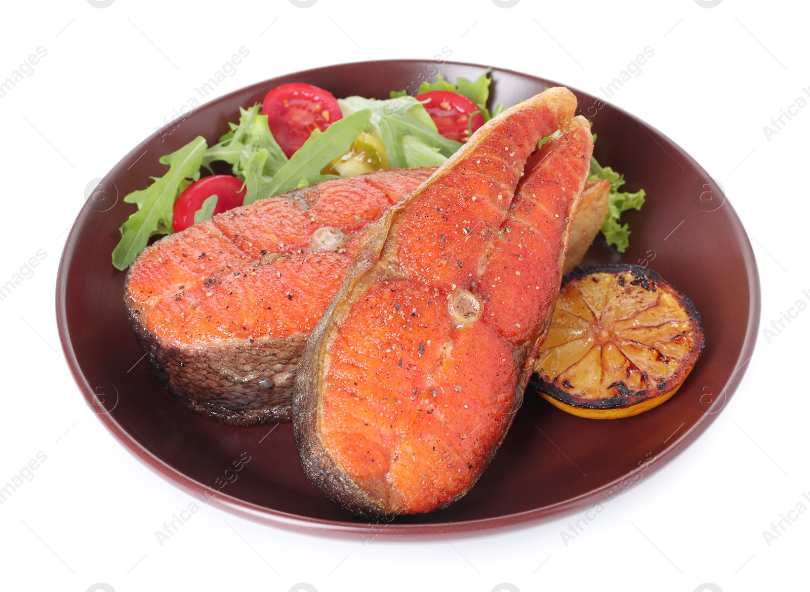 Seafood. Tasty salmon steaks, salad and lemon isolated on white Photo of Seafood. Tasty salmon steaks, salad and lemon isolated on white