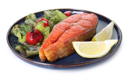 Photo of Seafood. Tasty salmon steak, salad and lemon isolated on white