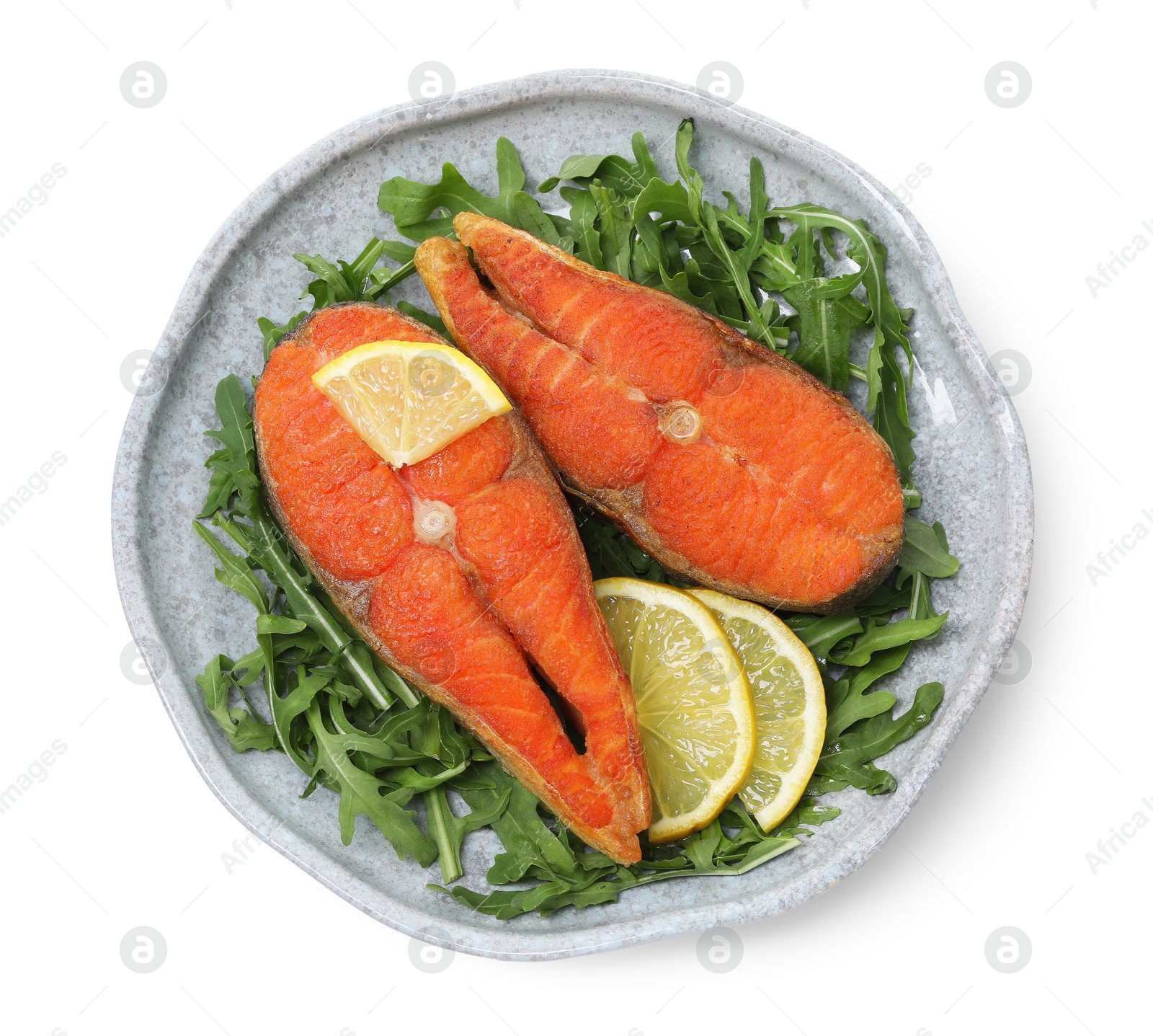 Seafood. Tasty salmon steaks, arugula and lemon isolated on white, top view Photo of Seafood. Tasty salmon steaks, arugula and lemon isolated on white, top view